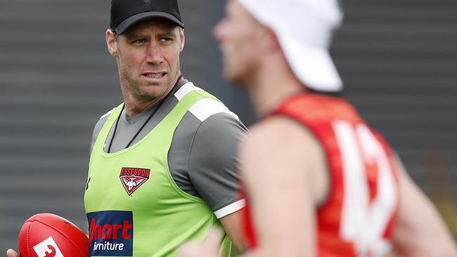 Essendon coach Ben Rutten keeps an eye on his players on day one of pre-season.