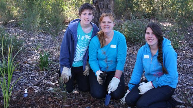 Thomas, Joanne and Maggie Somerville planting trees at Carysfield Park in 2014.