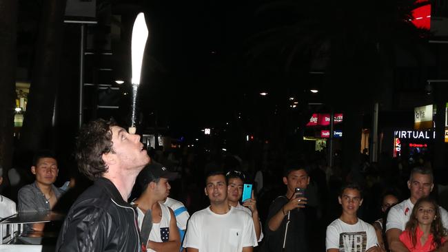 Juggling, busker and comedian Joel Fenton does his Friday night show Cavill Mall. Picture: Scott Fletcher