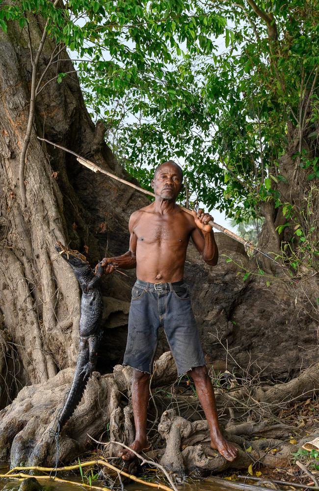 Fisherman Gerard Bokendaka, 64, poses for a photo with a crocodile and his spear on the banks of the Congo River. Picture: Arsene Mpiana/AFP