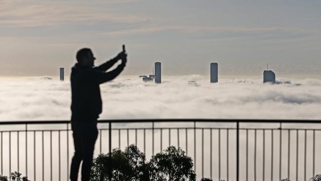 Brisbane City covered in fog, seen from the Mt Coot-Tha Summit Lookout. Picture: Zak Simmonds