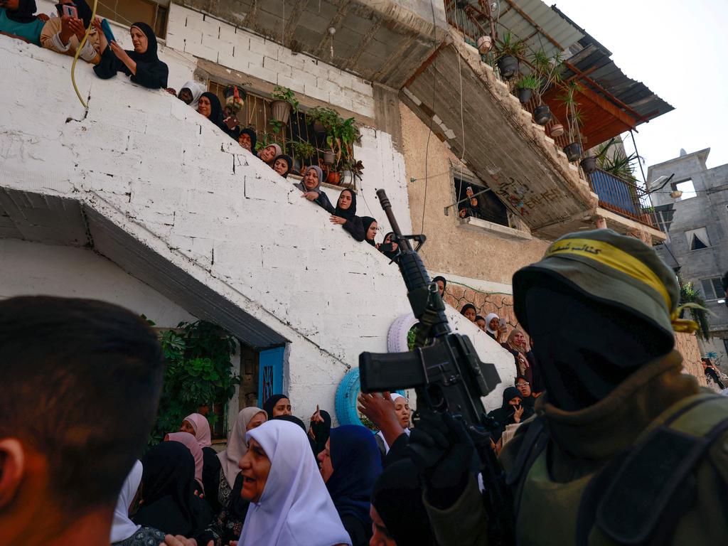 A fighter from the Al-Aqsa Martyrs' Brigades, a militant group linked to the Palestinian Fatah movement, walks with mourners in the funeral procession in Tulkarem of Mahmud Ali Hadayda, who was killed the previous day in clashes with Israeli forces in the northern West Bank city. Picture: AFP