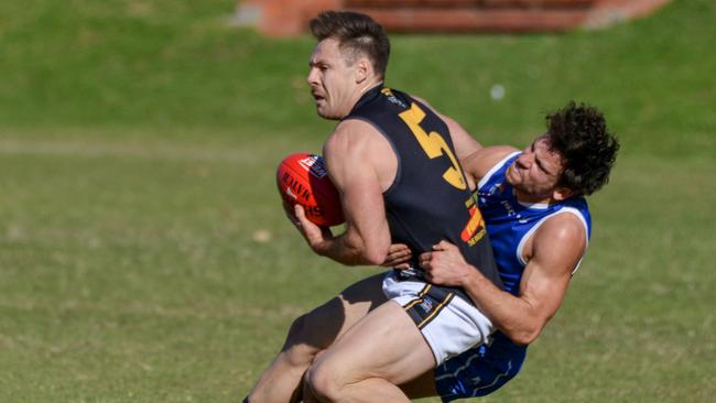 Brighton’s Nigel Osborn is tackled by SPOC’s John Vrodos during their division one clash on Saturday. Picture: Brenton Edwards