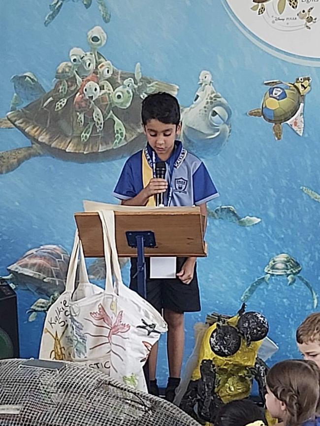 Student Zayd Habib welcomes GBRMPA's Josh Thomas and Dr David Wachenfeld to Kalkie State School.