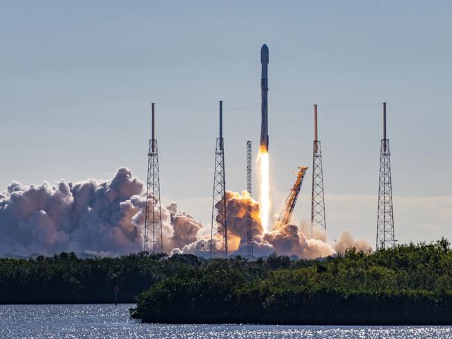 SpaceX Falcon 9 rocket and satellite payload launch in Florida. Booster are re-usable and either land at Cape Canaveral or on a barge at sea. Towers surrounding the launch pad are lightning arrestors.  Merritt Island National Wildlife Refuge, Florida, USA 01/03/2023Photo - GettyEscape 31 March 2024