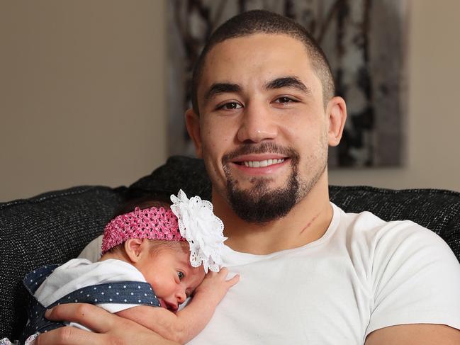 HOLD DO NOT USE WITHOUT PERMISSION FROM DAILY TELEGRAPH SPORT EDITORS - UFC champ Robert Whittaker with Australia's first title belt & his new baby daughter Lilliana and wife Sofia at their home in Mount Annan, Sydney. Picture: Brett Costello