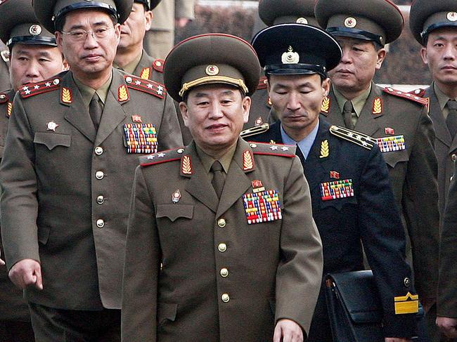 (FILES) In a file picture taken on December 13, 2007, North Korea's chief delegate Kim Yong Chol (C) and North Korean soldiers cross the border which divides the two Koreas to attend the inter-Korean general talks at the south side of the truce village of Panmunjom, in the Demilitarized Zone (DMZ).  US President Donald Trump confirmed on May 29, 2018, that a senior North Korean official is headed to New York for talks as preparations for his historic summit with Kim Jong Un gather pace. 