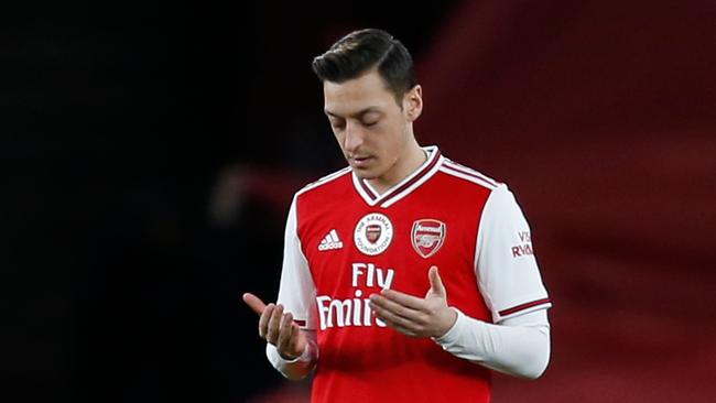 Arsenal’s Mesut Ozil prays before Sunday’s game in London. Picture: AFP.