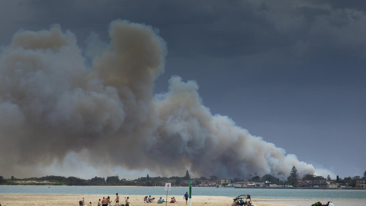 Peolple on Wallis Lake as the Tucurry fire strats to get hold. Picture: Shane Chalker