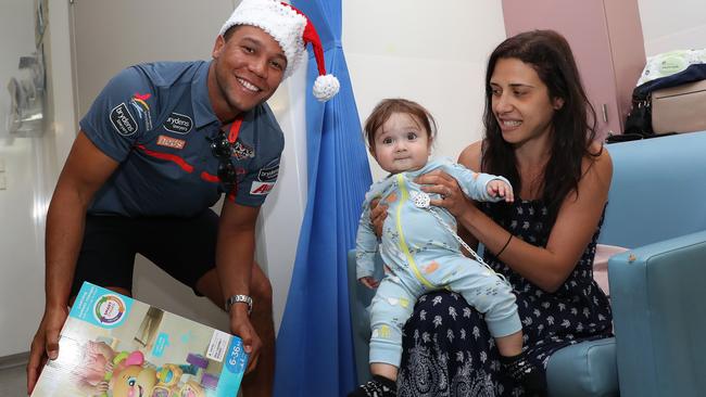 Mbye joined others Tigers giving gifts to sick children at Liverpool Hospital. Photo: Brett Costello