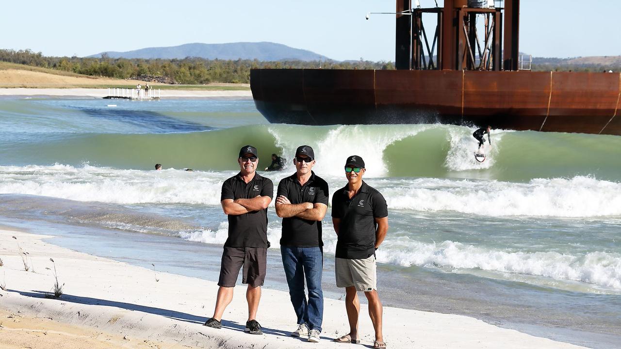 GNARLY PROJECT: General Manager Global Operations and International Media Director Wayne Dart (left), founder and CEO Aaron Trevis and Director Reuben Buchanan pose for a photo while the barrels roll in at Surf Lakes.