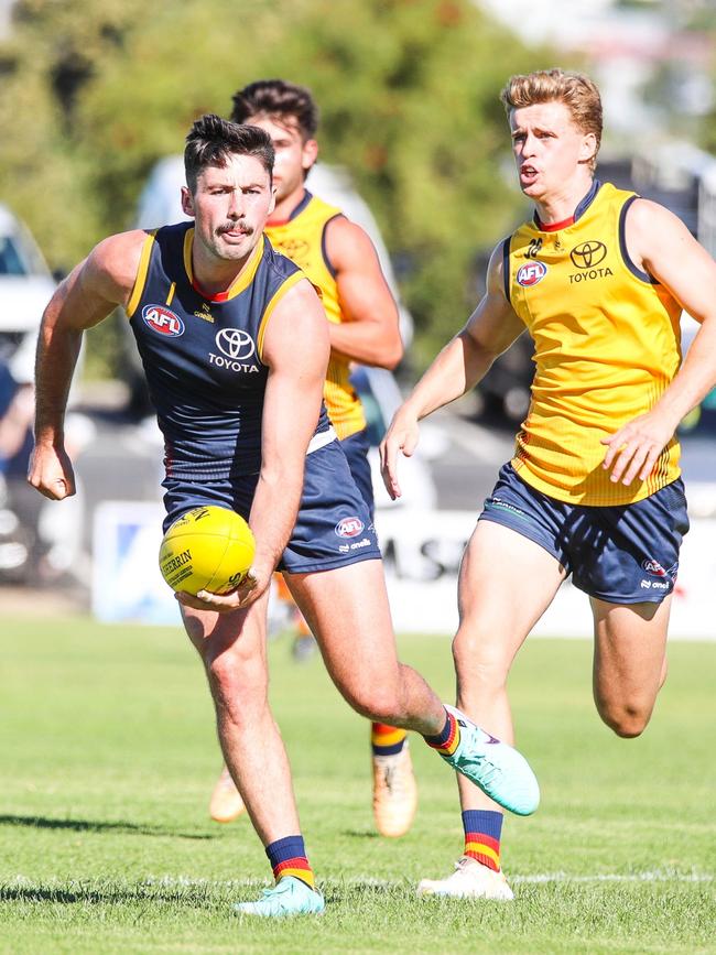 Irish recruit Karl Gallagher chases Chayce Jones. Picture: AFC