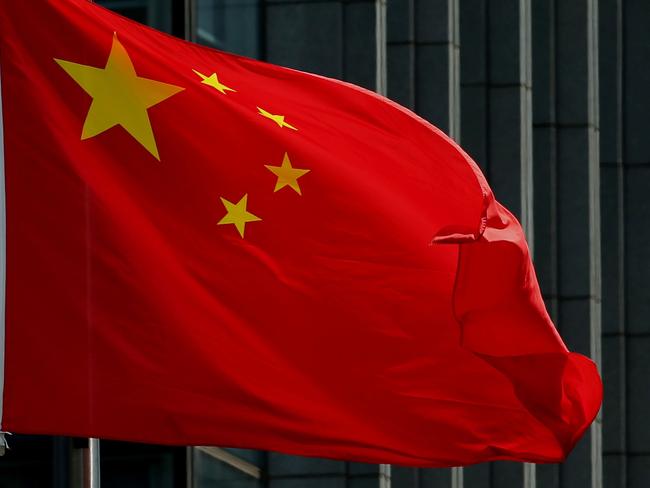 The Chinese national flag is seen on a flagpole in Beijing on August 8, 2016. Most of the five stars on the Chinese flags being used at medal ceremonies at the Rio Olympics are misaligned, officials said, prompting a diplomatic protest and online fury. / AFP PHOTO / STR