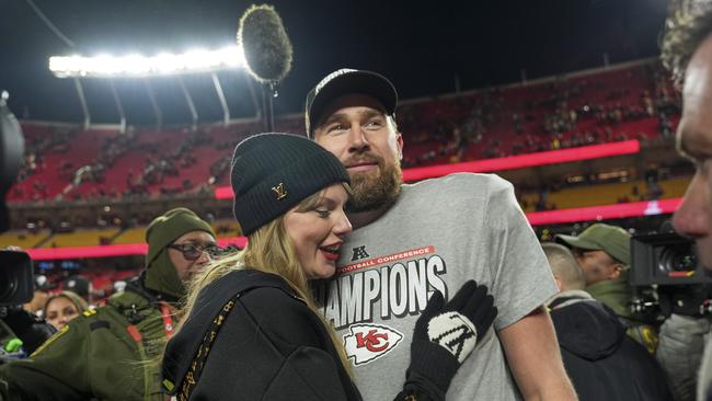 Kansas City Chiefs tight end Travis Kelce, right, is congratulated by Taylor Swift as they celebrate the Chiefs victory over the Buffalo Bills. (AP Photo/Charlie Riedel)