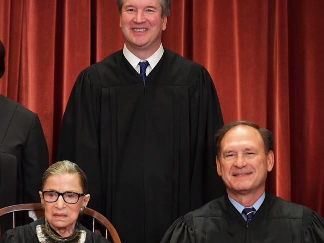 Justice Brett Kavanaugh (C, rear), who was a Trump appointment, and Justice Samuel Alito (R), appointed by George Bush, are conservative judges. A Trump administration replacement for Justice Ginsberg (L) will push the balance to conservative. Picture: AFP