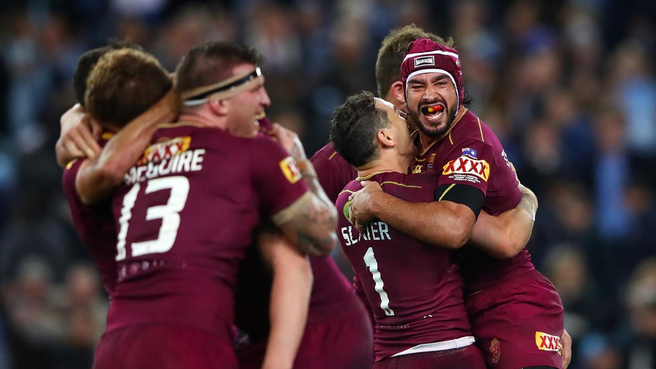 Johnathan Thurston of the Maroons celebrates with teammates.