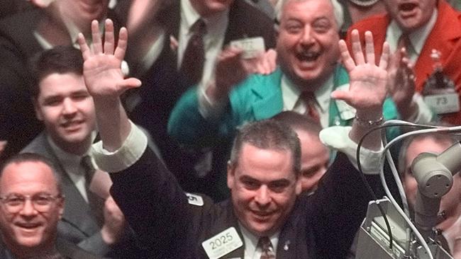 Traders clap their hands and yell while on the floor of the New York Stock Exchange after the DOW ended the day above 10,000 point for the first time in the Exchanges history Monday March 29, 1999. (AP Photo/Adam Nadel)