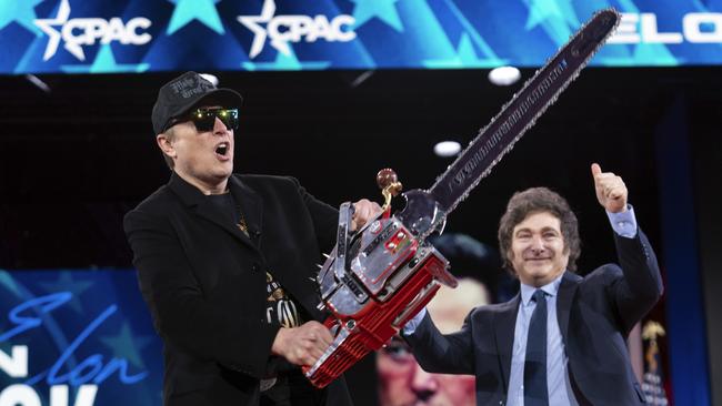 Elon Musk holds up a chainsaw he received from Argentina's President Javier Milei. Picture: AP Photo/Jose Luis Magana