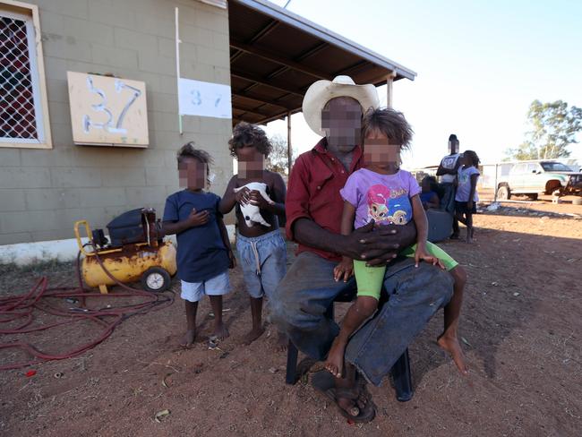 Dudley Hines with grandchildren at Nturiya community. Mr Hines refuses to let anyone who has been drinking come anywhere near his family. Picture: Gary Ramage/News Corp Australia