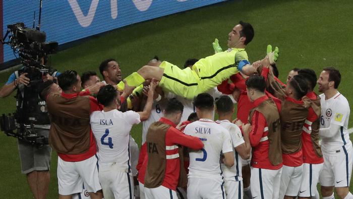 Chile goalkeeper Claudio Bravo is thrown in the air after winning the Confederations Cup, semifinal soccer match between Portugal and Chile, at the Kazan Arena, Russia, Wednesday, June 28, 2017. (AP Photo/Dmitri Lovetsky)