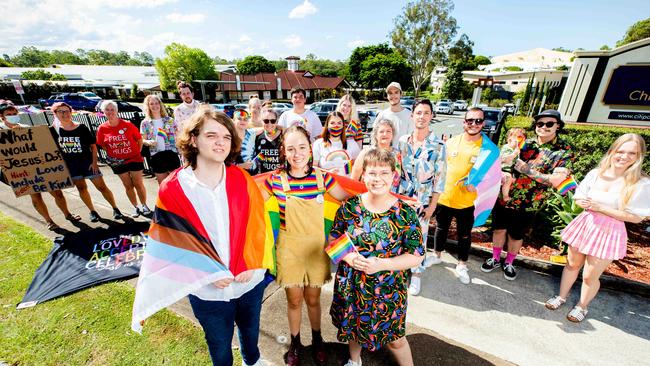 Emmey Leo, Felicity Myers and Bethany Lau protest outside Citipointe Christian College. Picture: Richard Walker