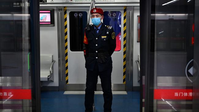 A security guard wearing a mask stands in a subway train in China. Picture: AFP