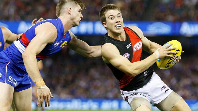 Billy Gowers collars Zach Merrett at Etihad Stadium.