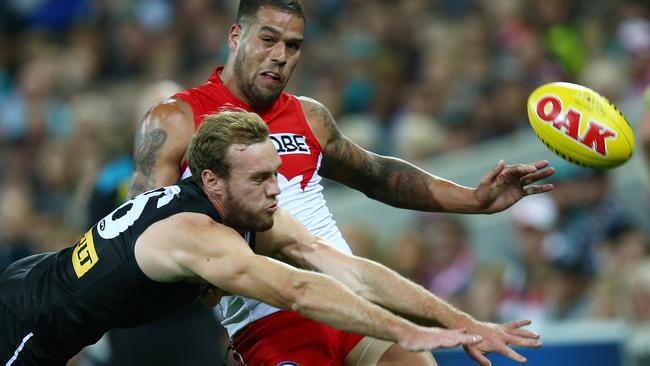 Typically desperate ... Jack Hombsch dives in an attempt to smother a kick by Lance Franklin. Picture: Sarah Reed