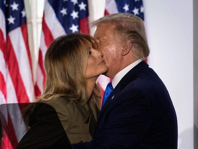 US President Donald Trump embraces first lady Melania Trump after she addressed the Republican Convention during its second day from the Rose Garden of the White House August 25, 2020, in Washington, DC. (Photo by Brendan Smialowski / AFP)