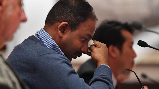 An emotional Vijay Vital, apartment owners in Mascot Towers, wipes away tears after delivering his opening statement to the Legislative Council Public Accountability Committee, Inquiry into Regulation of Building Standards, Building Quality and Building Disputes at New South Wales Parliament in Sydney, Monday, August 12, 2019. (AAP Image/Dean Lewins) NO ARCHIVING