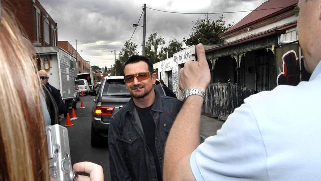 Bono meets a few fans outside the Corner Hotel. U2 filming a video clip at the Corner Hotel in Richmond. Picture: News Corp Australia.