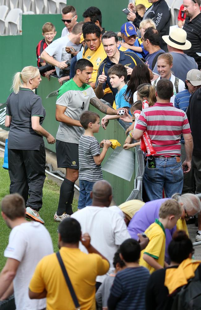 Tim Cahill making sure he got to every fan till the end as the players waited in the bus. Standing with him is Tim Jelacic. Tim has been battling a brain tumour at just aged 2 years and 10 months. Picture: George Salpigtidis