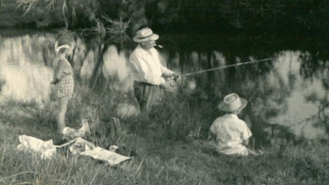 Vladimir Petrov fishes in the Nerang River on the Gold Coast with Mark Doherty as Sue-Ellen watches on.