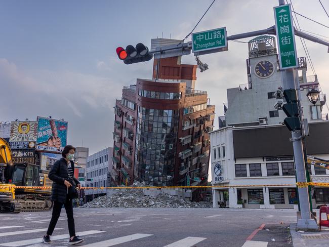 A person walks by a damaged building in Hualien, Taiwan, following the region’s 7.5 earthquake. Picture: Annabelle Chih/Getty Images