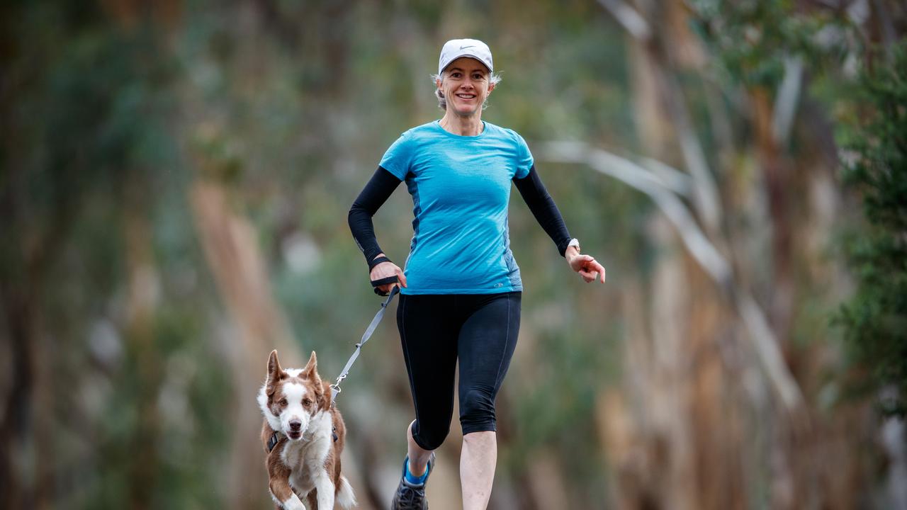 Prof Spurrier goes for a run with her dog Daisy at Belair National Park. Picture MATT TURNER.