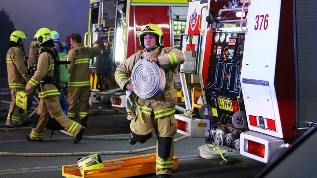 Firefighters in action as the Newcastle CBD pub in Hunter St is engulfed by flames. Picture: Peter Lorimer