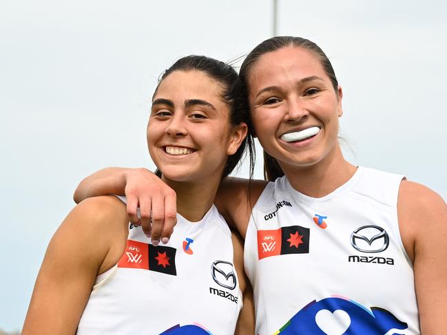 HOBART, AUSTRALIA - OCTOBER 13: Taylah Gatt and Niamh Martin of the Kangaroos celebrate the win during the round seven AFLW match between North Melbourne Kangaroos and Sydney Swans at North Hobart Oval, on October 13, 2024, in Hobart, Australia. (Photo by Steve Bell/AFL Photos/via Getty Images)