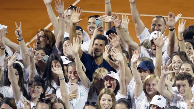 Serbia’s Novak Djokovic, centre, poses with volunteers and players after the Adria Tour charity tournament in Belgrade, Serbia