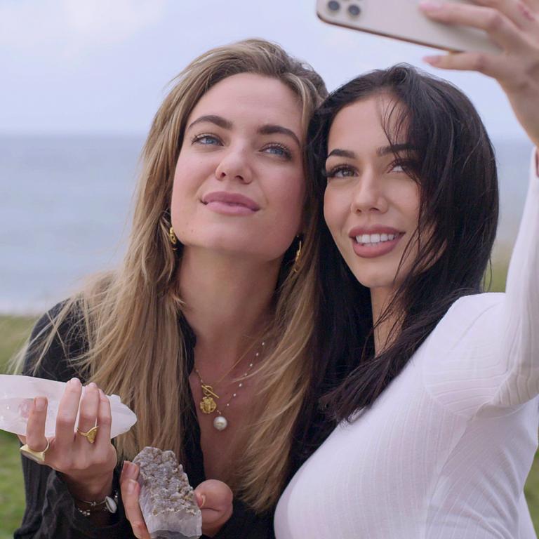 Cast members Hannah Brauer and Sarah Tangye get a selfie with their crystals. And to think the residents of Byron Bay were worried! Picture: Netflix