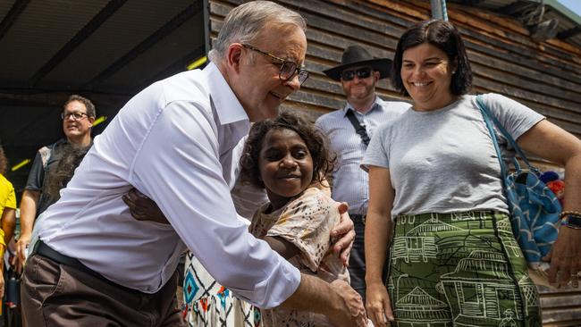 Prime Minister Anthony Albanese embraces a young Yolngu child during Garma Festival on Saturday. Picture: Getty Images