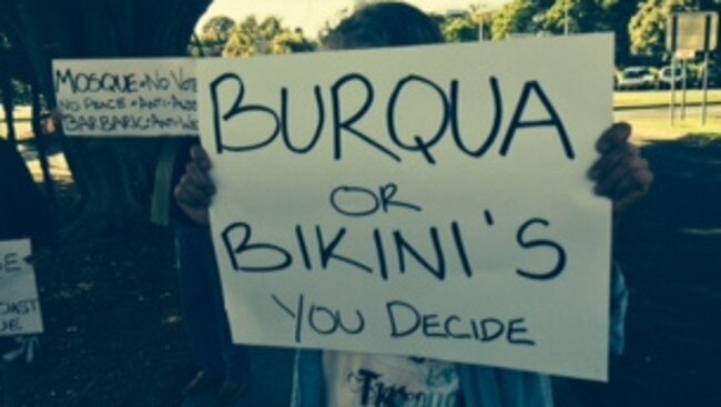 Protesters hold placards at the protest outside Gold Coast City Council chambers. Pic: Andrew Potts