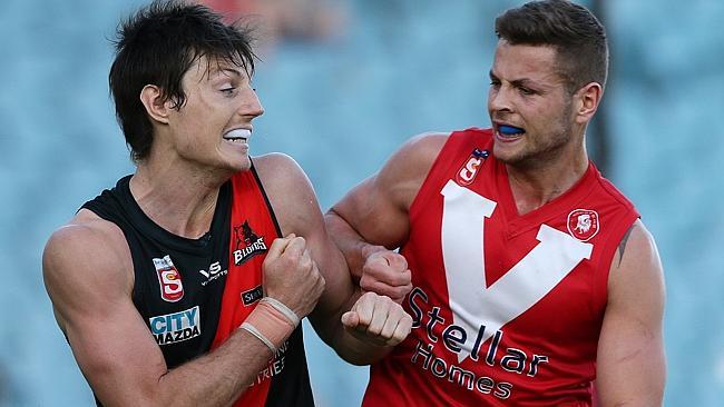 West Adelaide's Joel Tippett, left, clashes with North Adelaide's Tom Langford during the 2013 SANFL preliminary final. Picture: Sarah Reed.