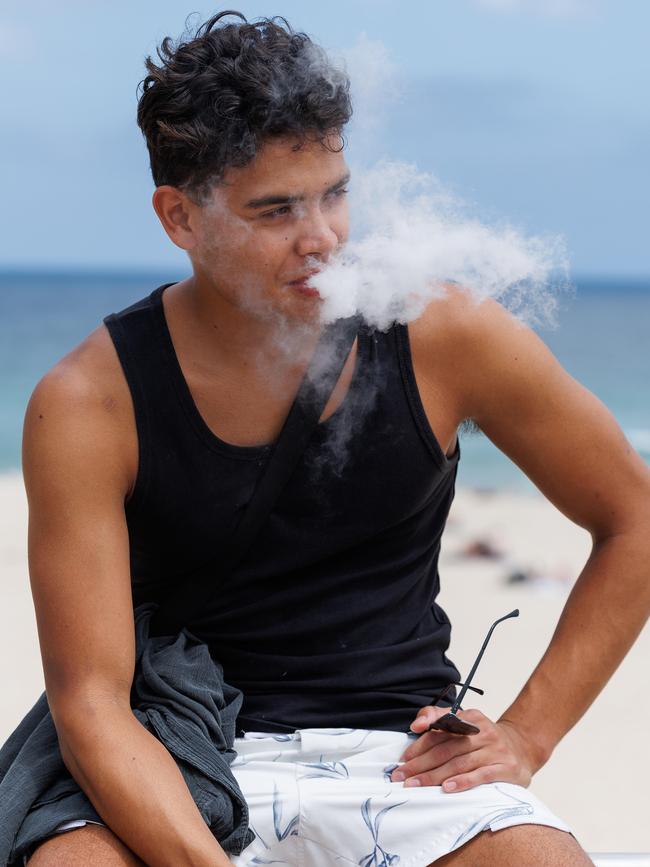 Luca Cruzado, 20 pictured vaping at Bondi. Some of the effects of vaping include addiction, poisoning, acute nicotine toxicity – known as getting “nic-sick” – burns and lung injuries. Picture: NCA NewsWire / David Swift