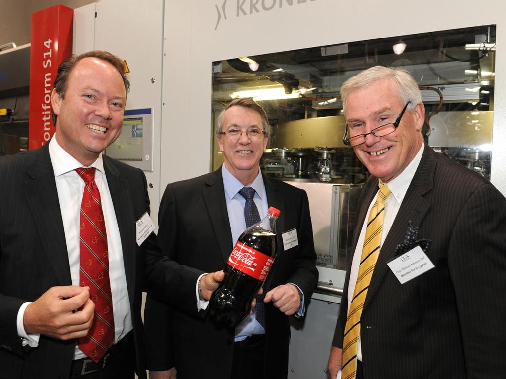 Coca-Cola Amatil managing director Australasia Warwick White, CCA supply chain manager SA Martin Cowley and SA politician Michael Atkinson in front of the “blowfill’’ self-manufacture equipment at the CCA factory at Thebarton in 2011. Picture: Supplied