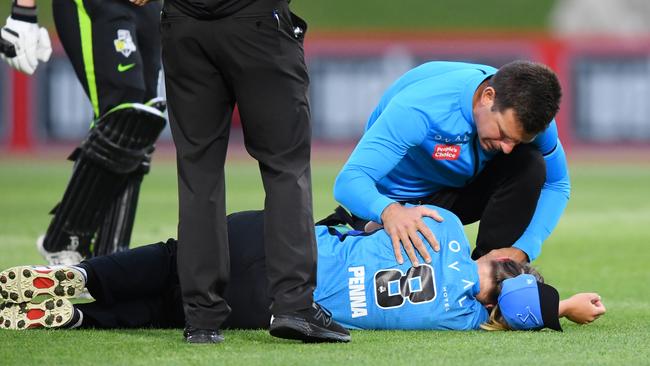 Maddie Penna of the Adelaide Strikers goes down after being hit while fielding. Photo by Mark Brake/Getty Images