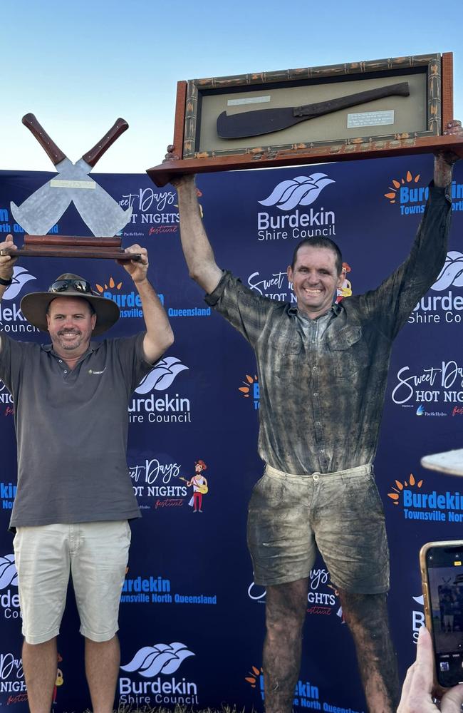 Winner of the Australian Hand Cane Cutting Championships 2023 Adam Gilbert (right) presented by CANEGROWERS chairman Owen Menkens.