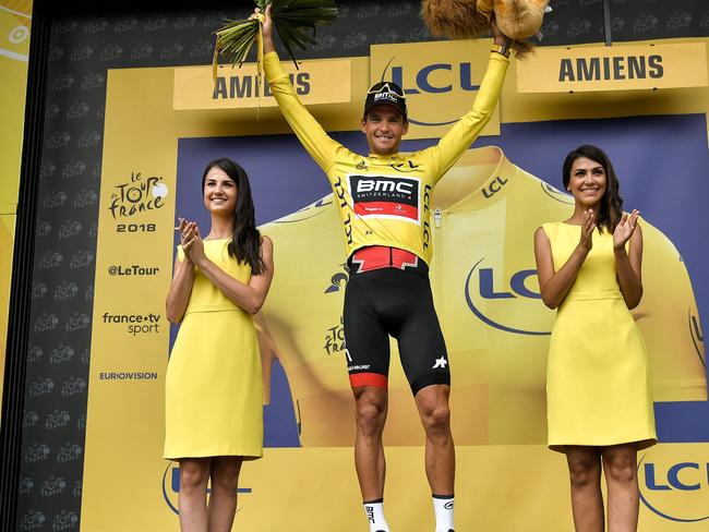 Belgium's Greg Van Avermaet, wearing the overall leader's yellow jersey, celebrates on the podium after the eighth stage of the 105th edition of the Tour de France cycling race between Dreux and Amiens, northern France, on July 14, 2018. / AFP PHOTO / Marco BERTORELLO