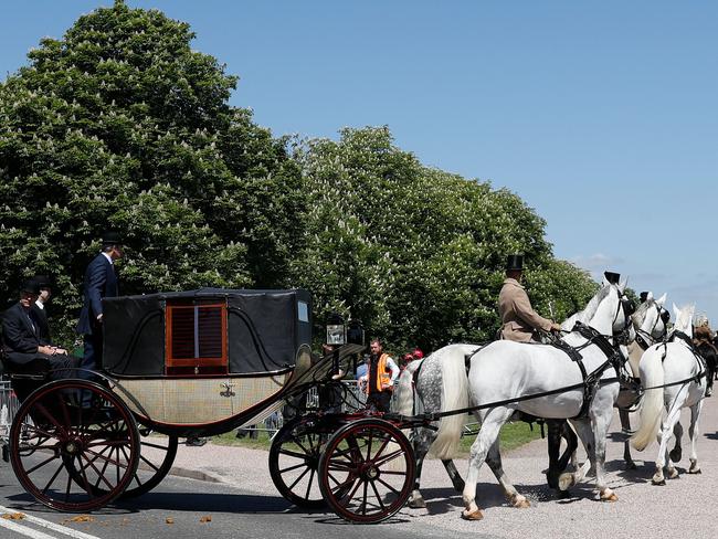 The Ascot Landau carriage pulled by Windsor Grey horses takes the turn onto the Long Walk heading toward Windsor Castle during a rehearsal for the wedding procession in Windsor. Picture: AFP