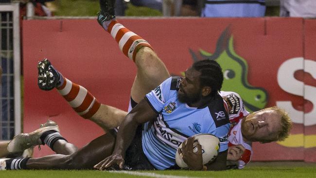 Edrick Lee beats the tackle of James Graham to score during a match between the Dragons and the Sharks in 2018. Picture: AAP