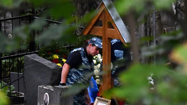 Police officers stand by the grave of Yevgeny Prigozhin after his funeral in August. Picture: AFP